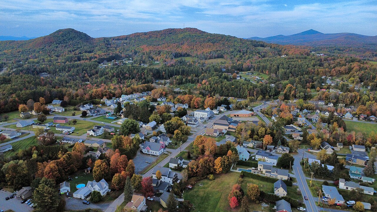 East Barre from above, houses scattered along the road with hills behind.