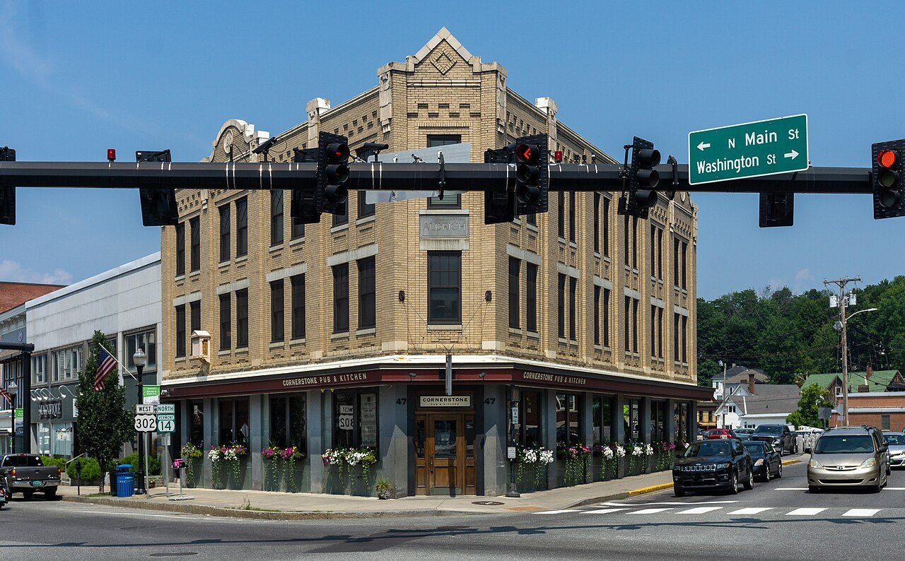 The Aldrich Building on a Barre street corner, a tan block with a decorated cornice.