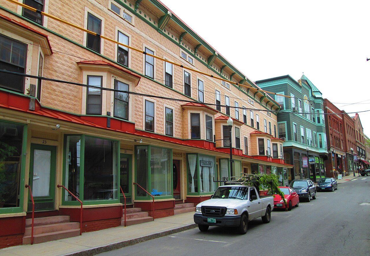 Canal Street in Bellows Falls from the north, brick blocks with painted cornices above the street.