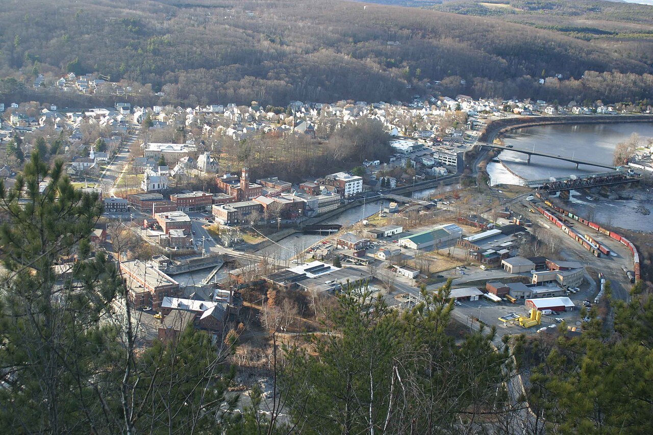 Bellows Falls from the hillside, the mill buildings and the river crossing at the bottom of the valley.