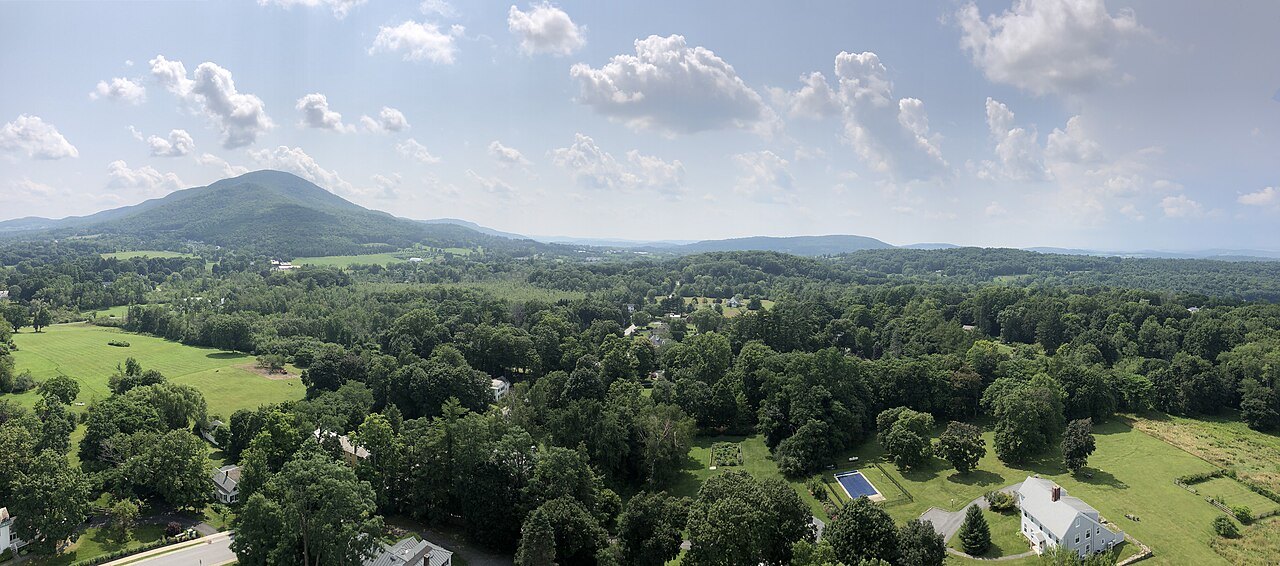 A panoramic view over the Bennington valley, with a green hill on the horizon.