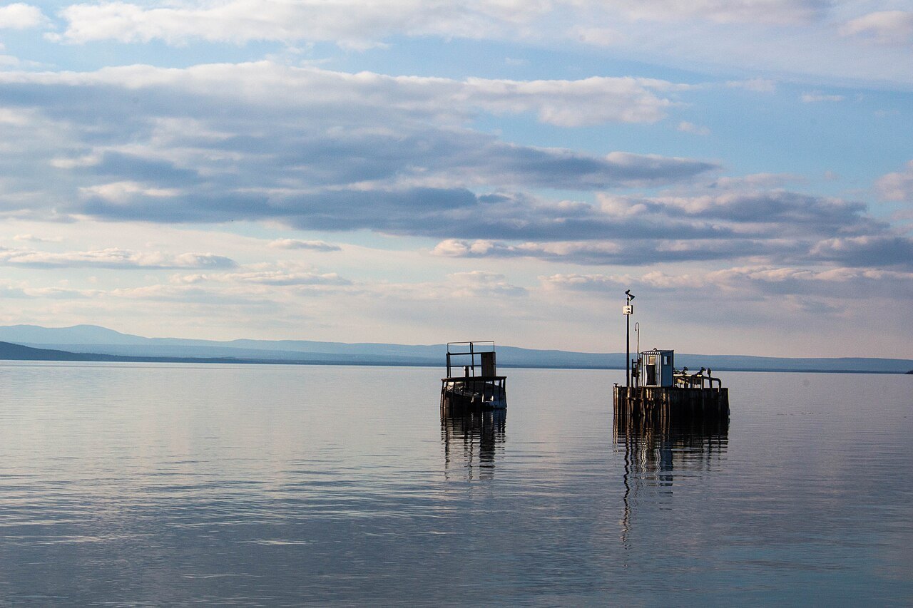 Two channel markers standing in calm water on Lake Champlain off Burlington.
