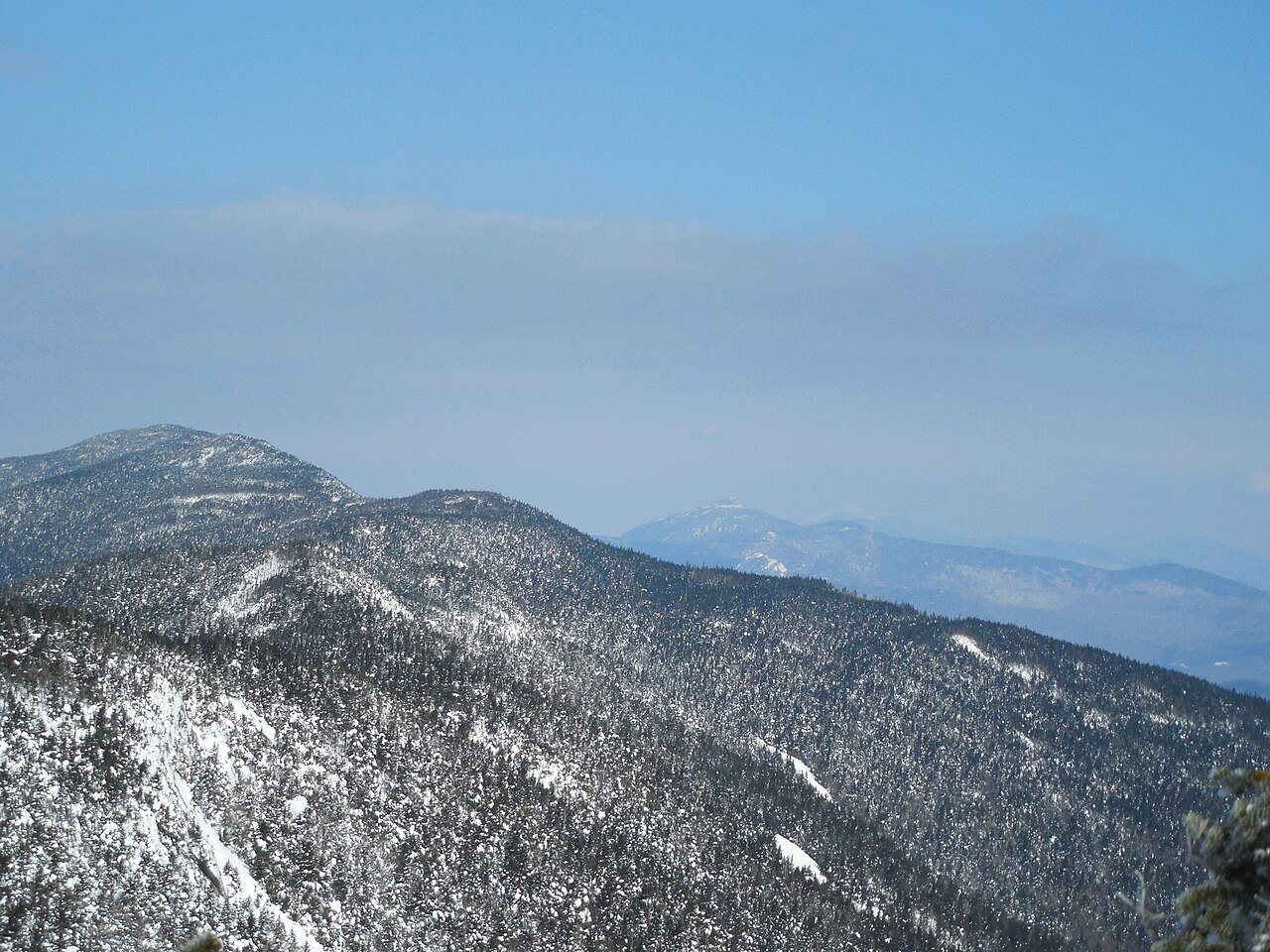 Camel's Hump from the slopes of Mount Ellen in winter, the ridge dusted with snow.