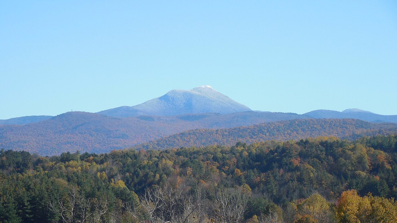 Camel's Hump from the west, a pale peak above dark forest.
