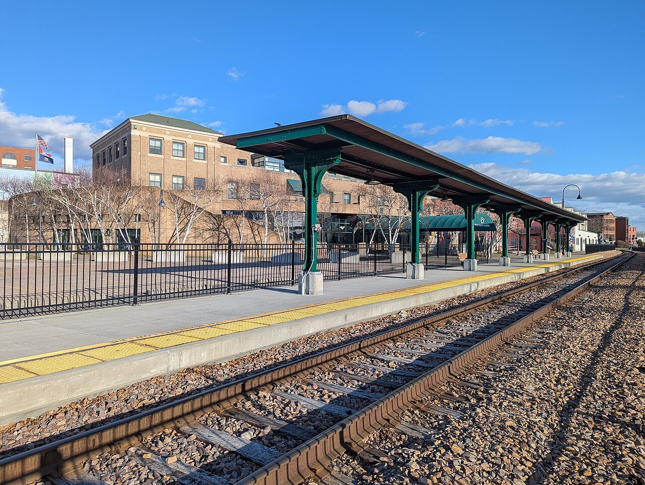 The tracks and canopy at Burlington Union Station on a bright day.