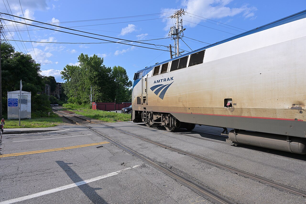 A Vermonter locomotive departing Brattleboro along the rails.