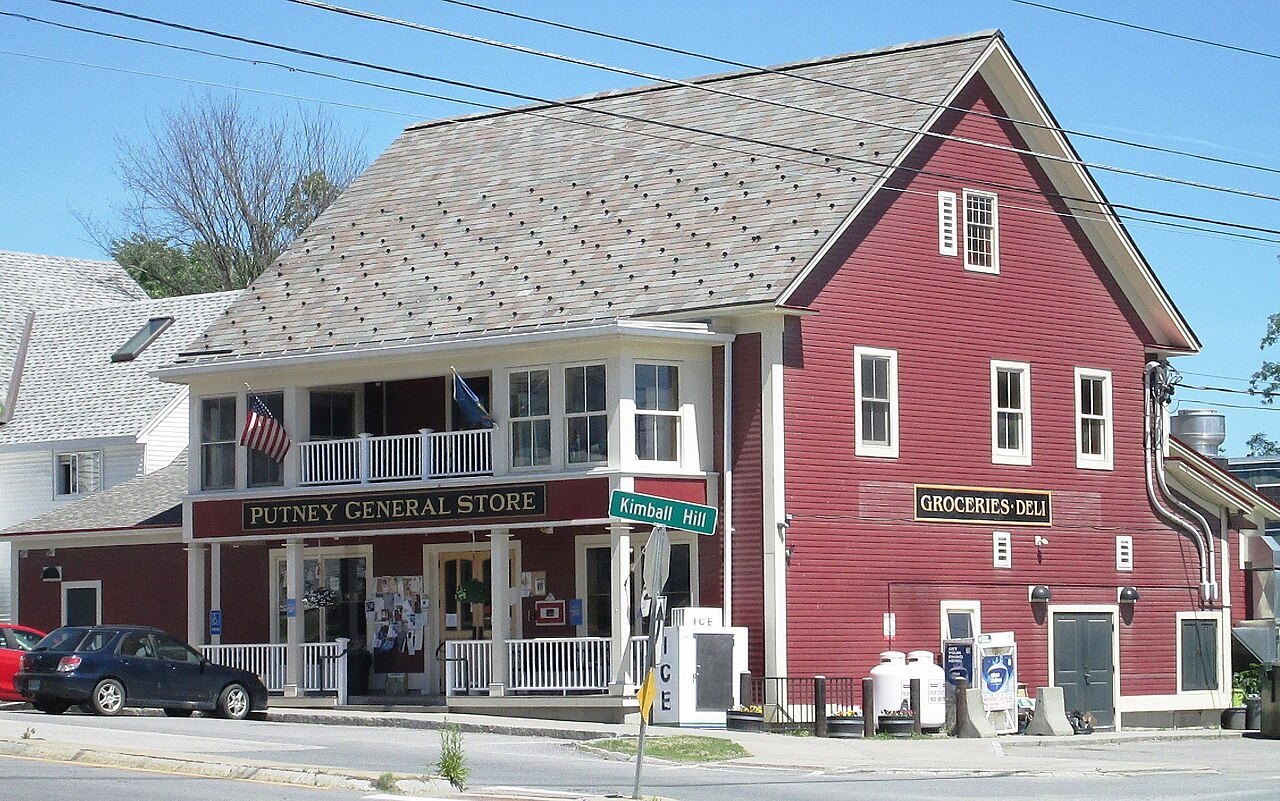 The Putney General Store, a red building with a wide porch on a village corner.