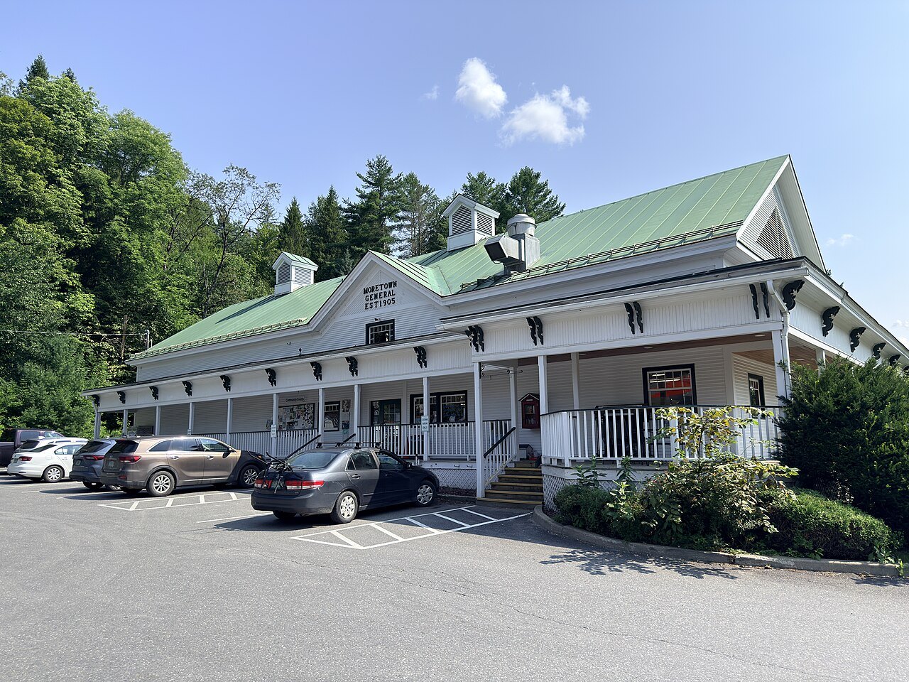 The Moretown General Store, a long white building with a green roof and a porch.