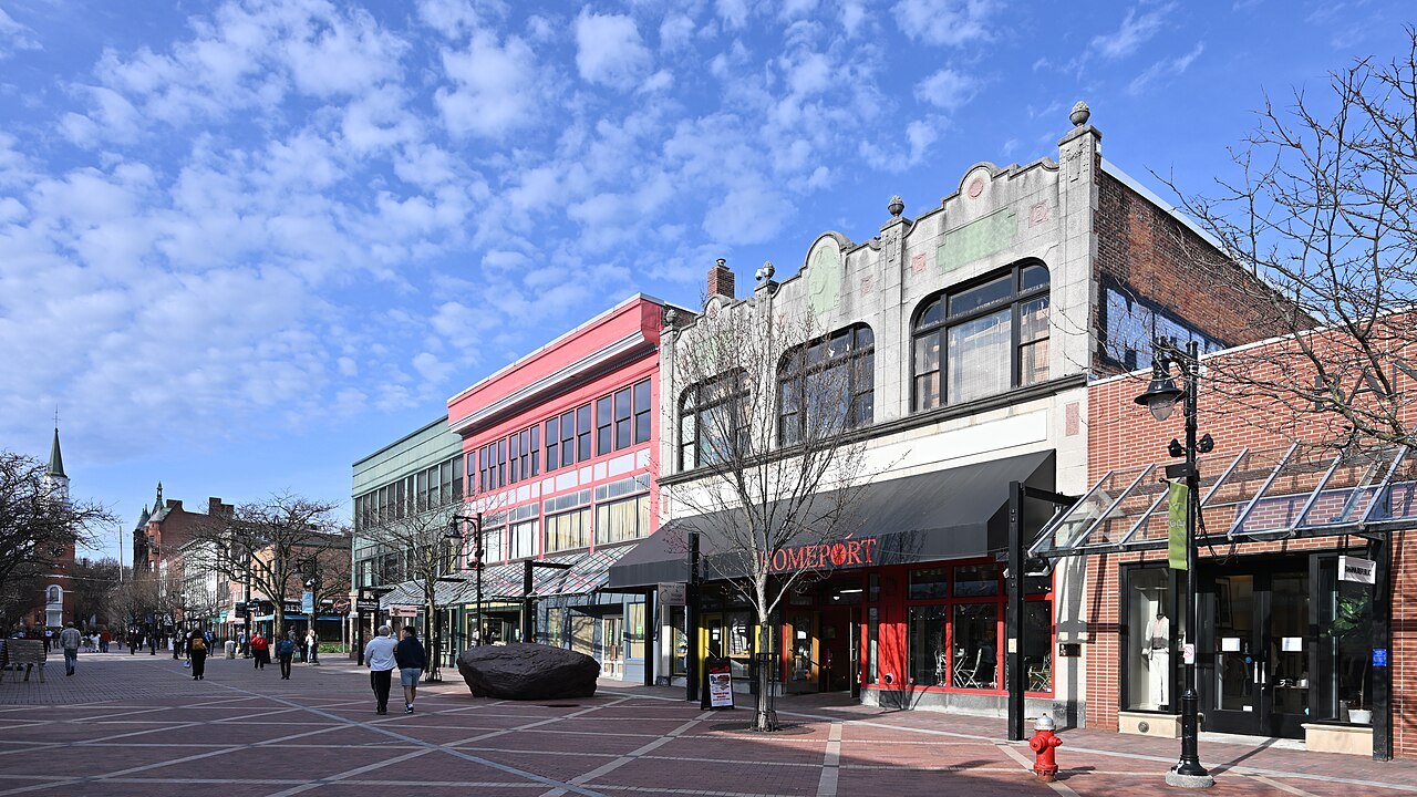 Church Street in Burlington, a brick-paved pedestrian street lined with shops under a bright sky.
