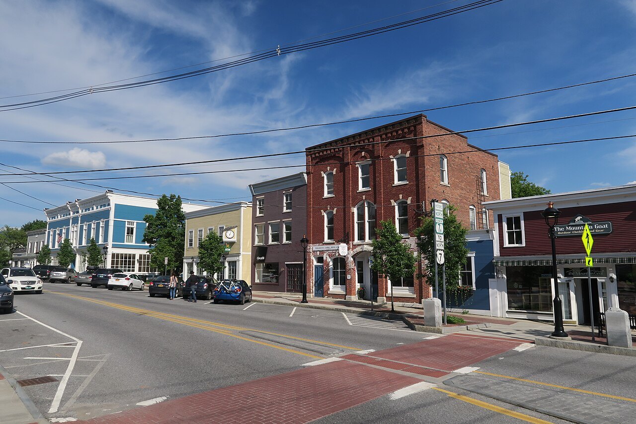 Main Street in Manchester Center, a brick-paved crossing between old commercial blocks.