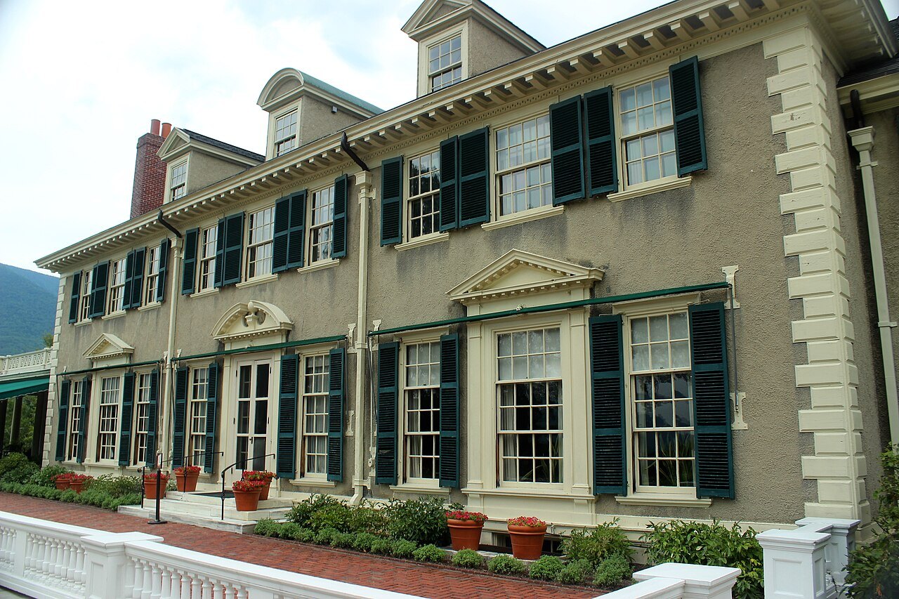 The facade of Hildene, with rows of shuttered windows and pilasters.
