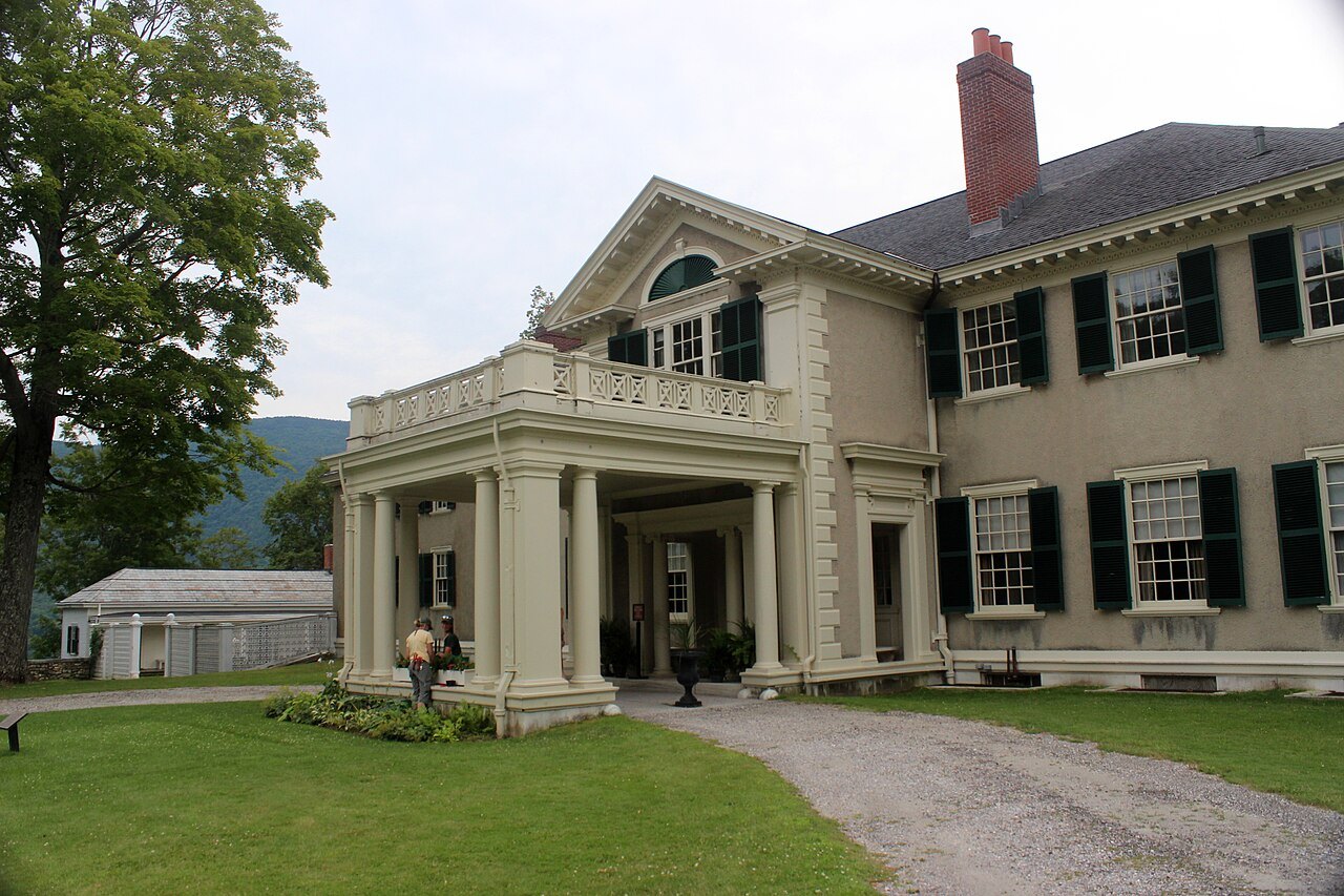 The Georgian Revival porch, with columns and a balcony above the drive.