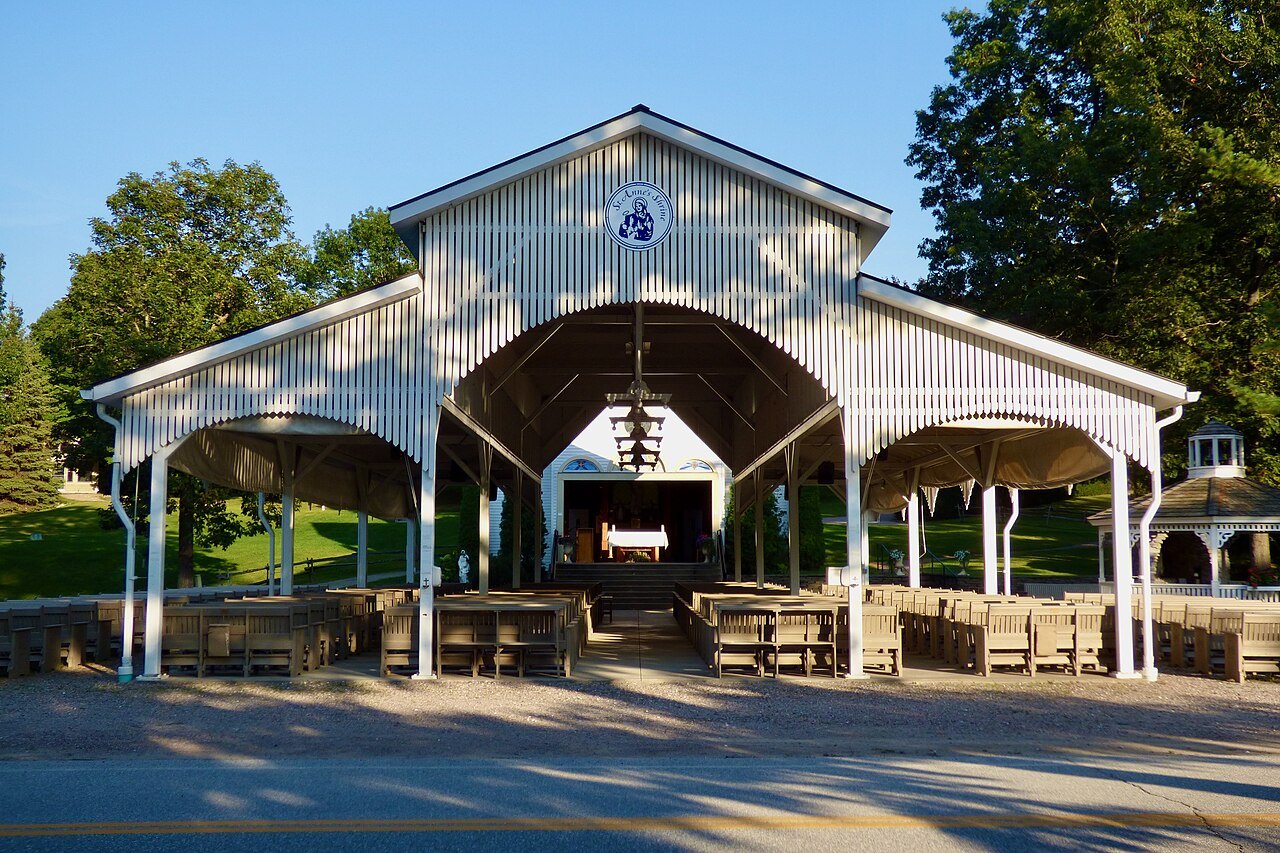 The outdoor chapel at Saint Anne's Shrine on Isle La Motte, a white open-sided pavilion with rows of benches.
