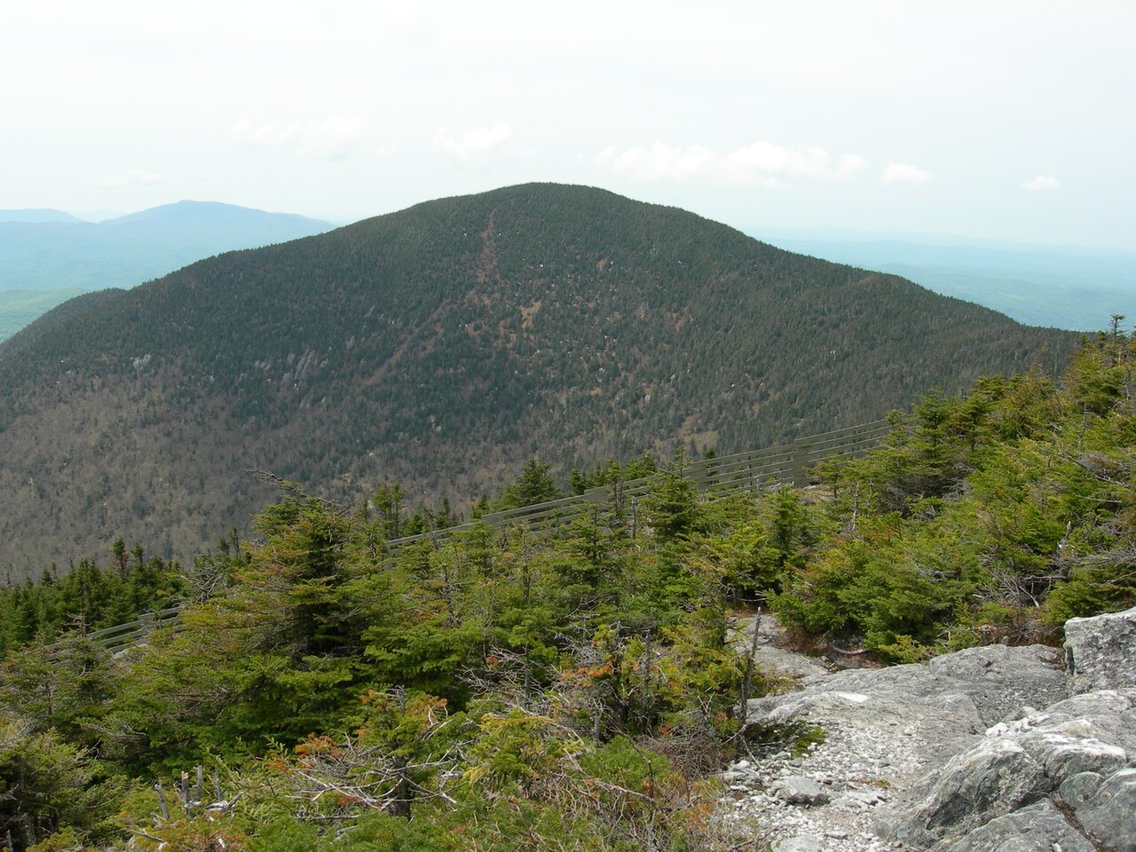Big Jay from the summit of Jay Peak, with bare rock in the foreground.