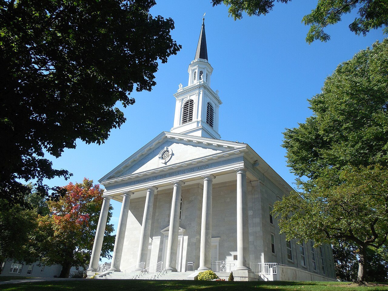 Mead Chapel at Middlebury College, a white building with a spire, in autumn light.