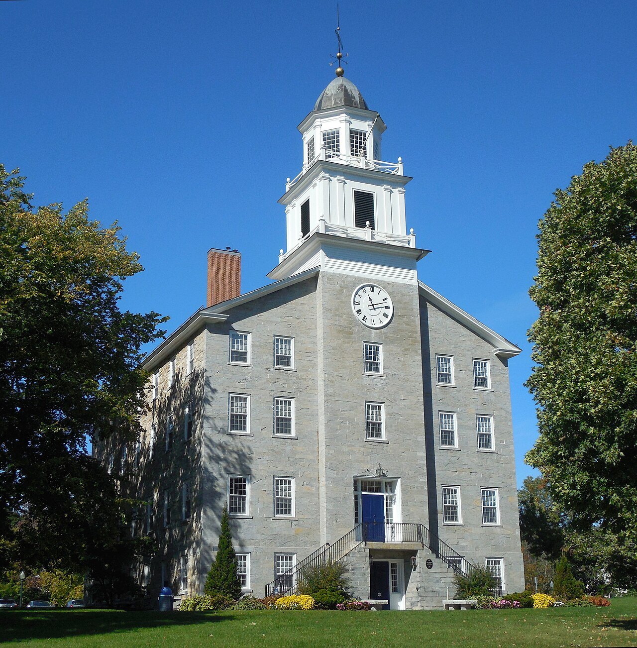 Old Chapel at Middlebury College, a gray stone building with a clock cupola.