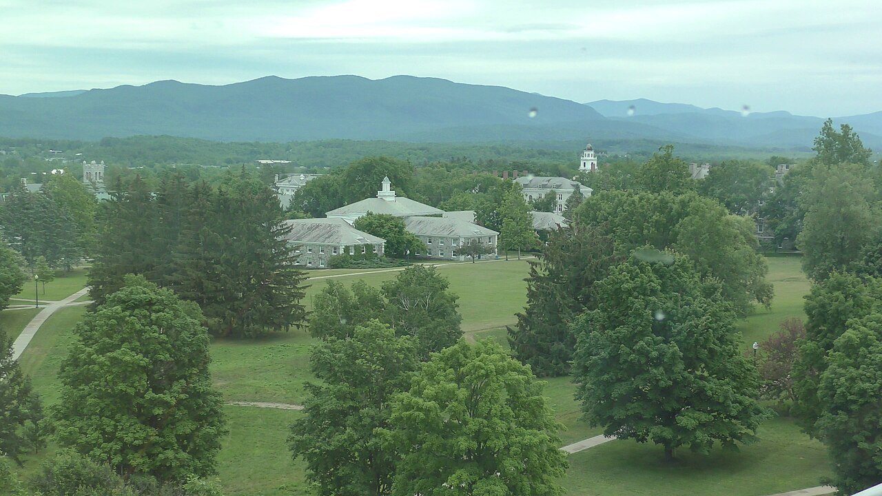 Middlebury College campus from above, lawns and trees below the hills.
