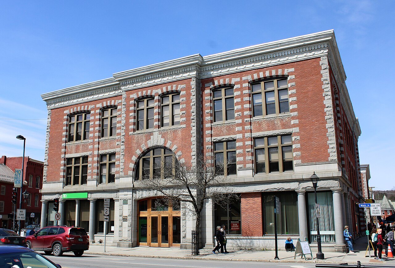 The Langdon Block, a red-brick commercial building with rounded arches, on a Montpelier corner.