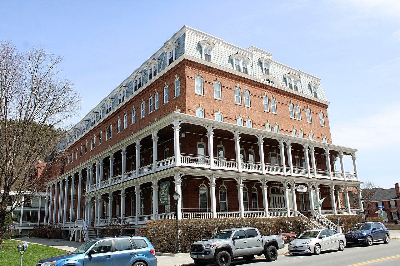 The Pavilion, a four-story brick building with a mansard roof and long wooden porches.