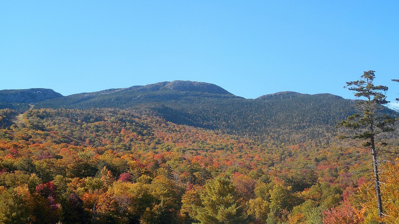 Mount Mansfield from the summit ridge, with autumn color across the lower hills.