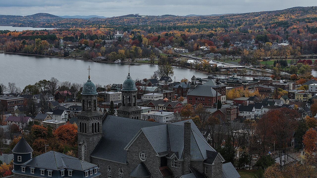 Newport in October from above, steeples among autumn trees beside the lake.