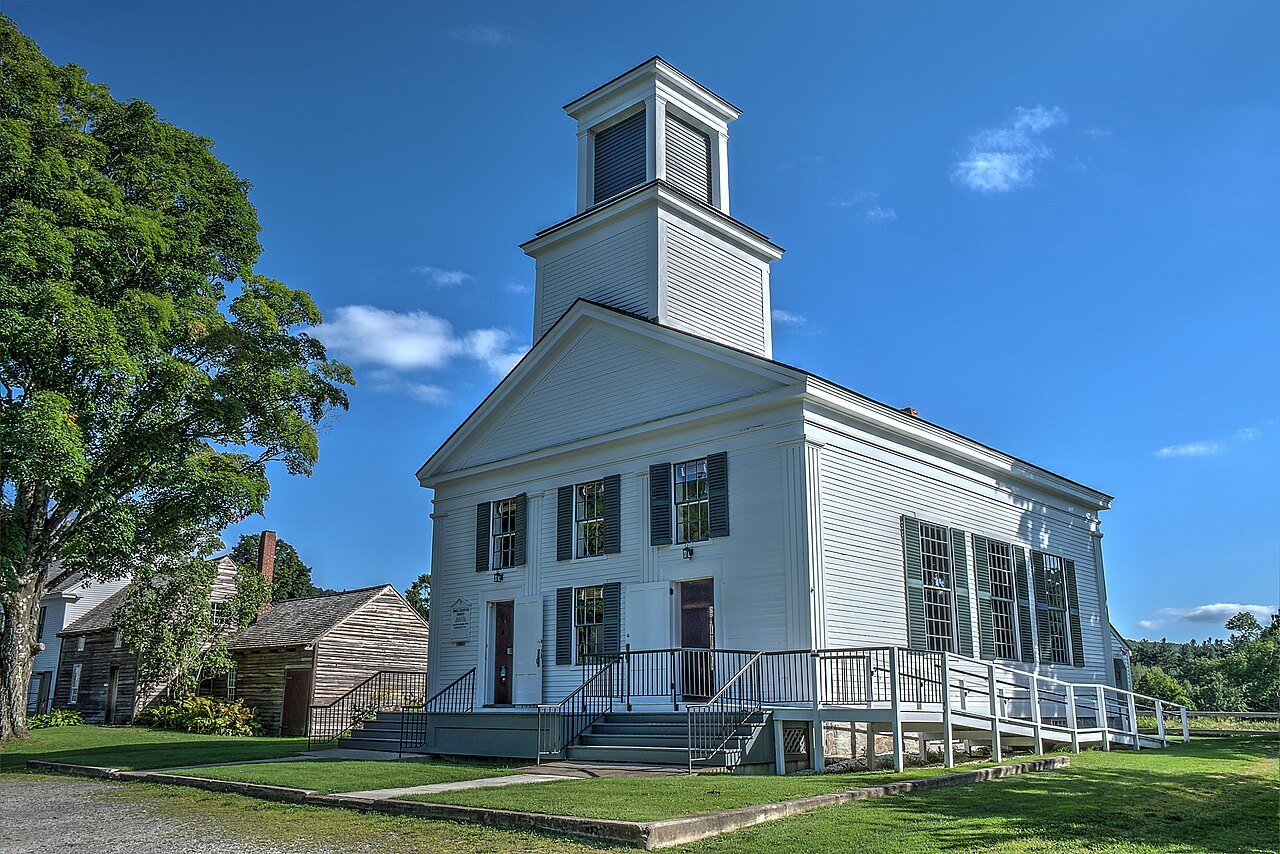 The Union Christian Church in Plymouth Notch, a white building with a belfry, under a blue sky.