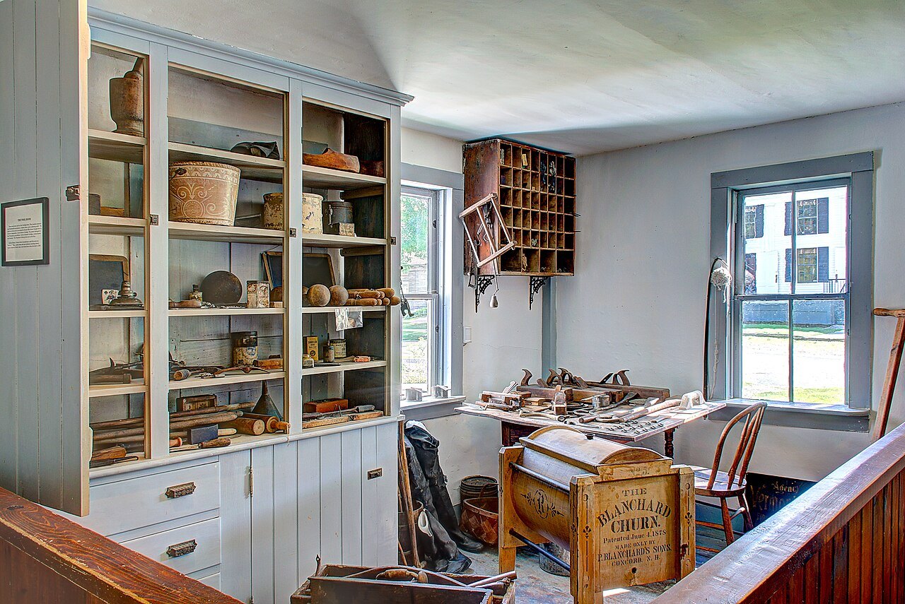 A room with open shelves, pigeonholes and a desk below a window, kept as it was.