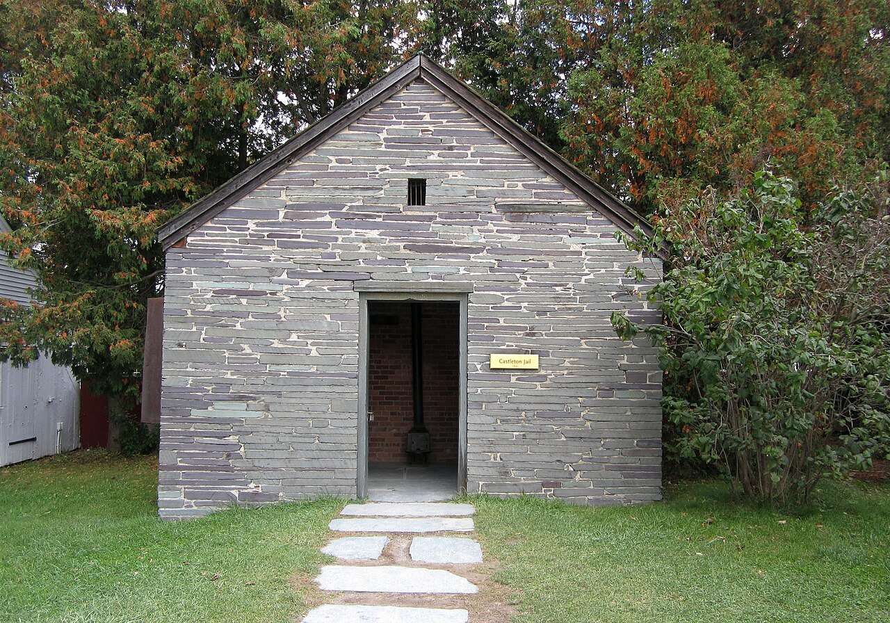 The Castleton Jail, a small stone building with an open door.