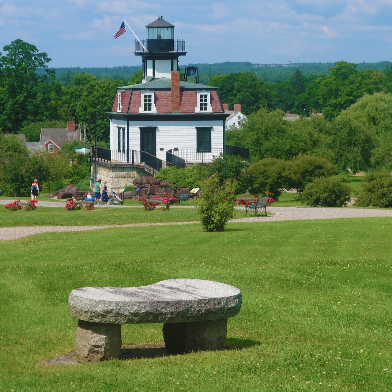 The Colchester Reef Light, re-erected on the lawn at the Shelburne Museum, with a stone bench in front.