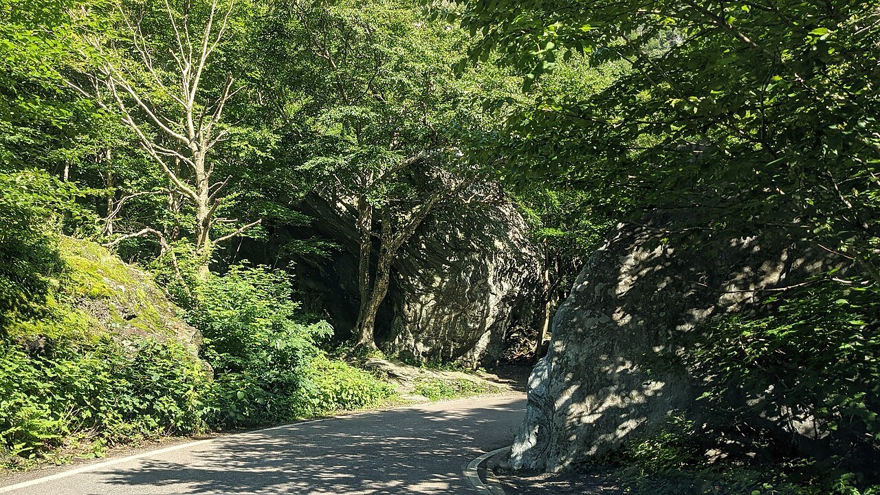The narrow road through Smugglers' Notch between boulders and cliff.