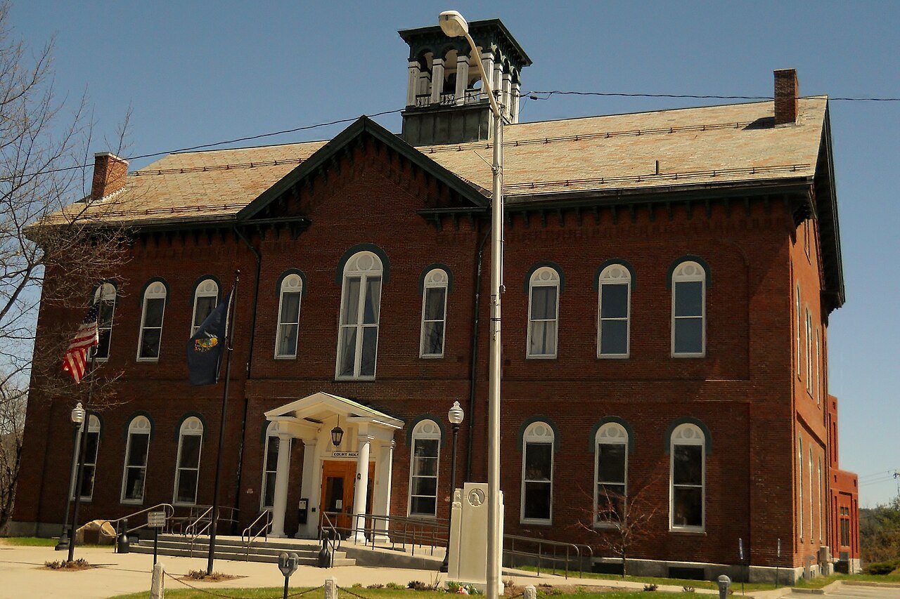 The Caledonia Superior Court, a red brick building with tall windows and a small tower.
