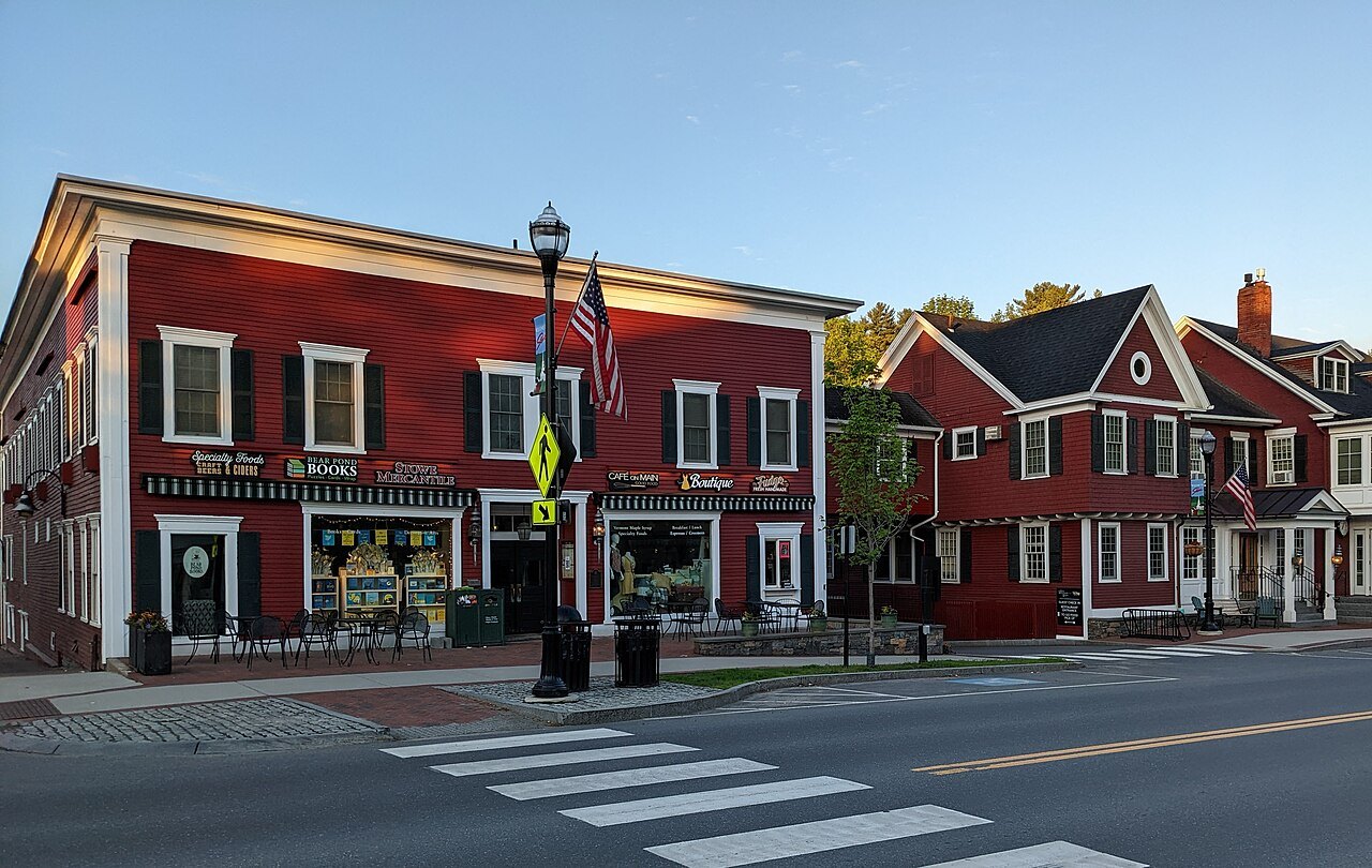 The Depot Building in Stowe, red clapboard shops beside a crosswalk.