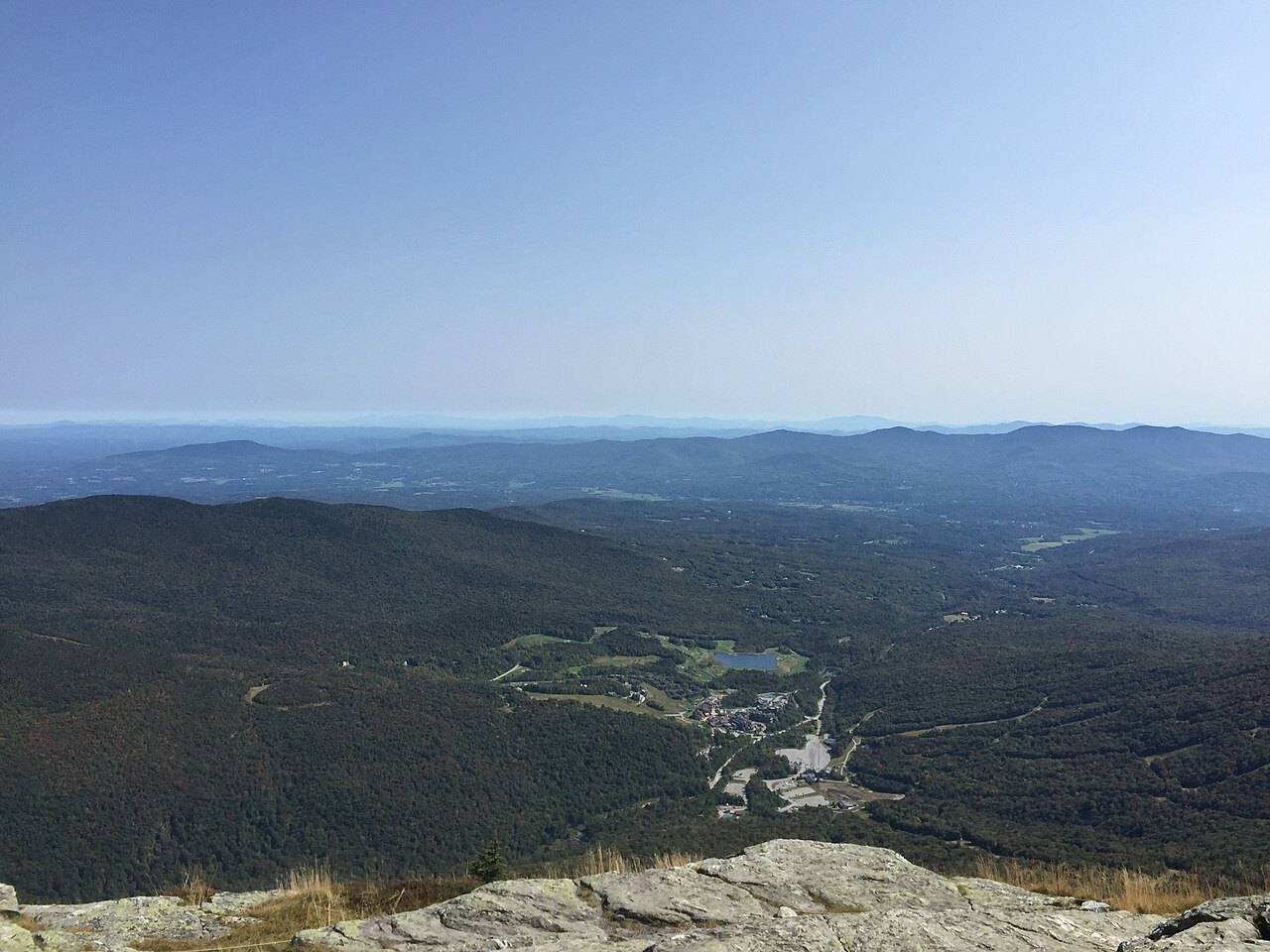 A hazy view east from a ridge of the Long Trail over forested hills and valleys.