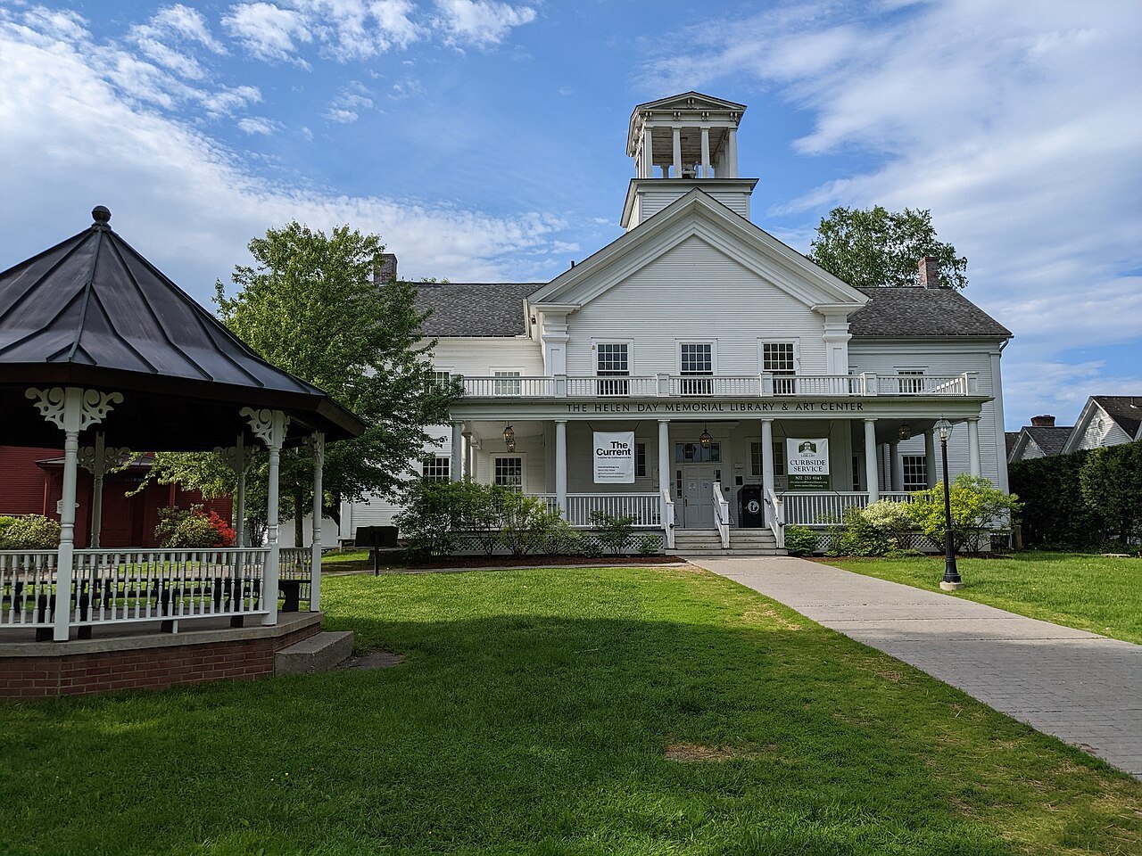 The Helen Day Memorial Library and Art Center, a white building with a cupola and a red gazebo.