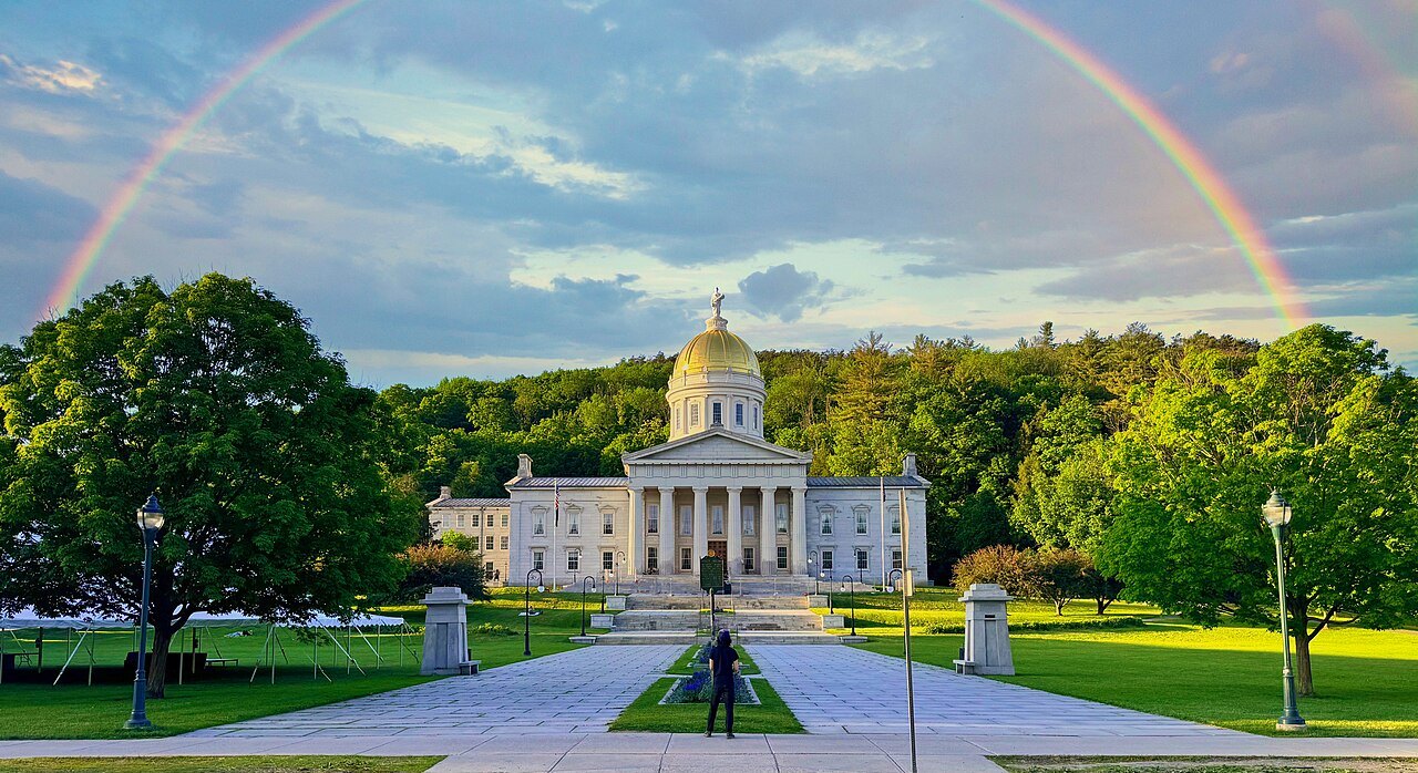 A rainbow over the State House and its lawn.