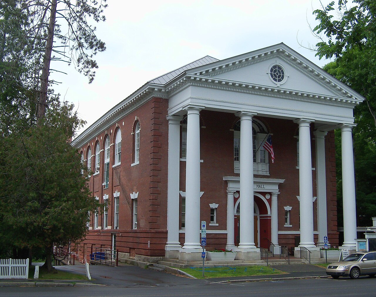 Woodstock Town Hall, a red-brick building with four white columns.